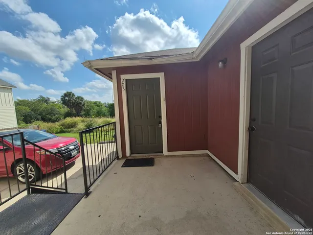 a view of a porch with furniture and a yard