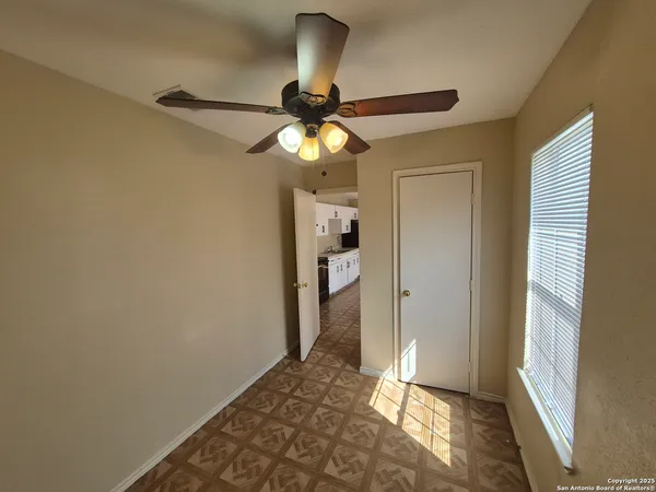 a view of a chandelier fan and wooden floor