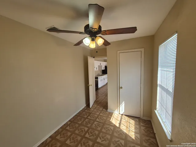 a view of a chandelier fan and wooden floor