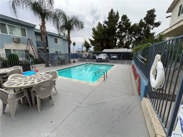 a view of a house with entryway and a wooden fence