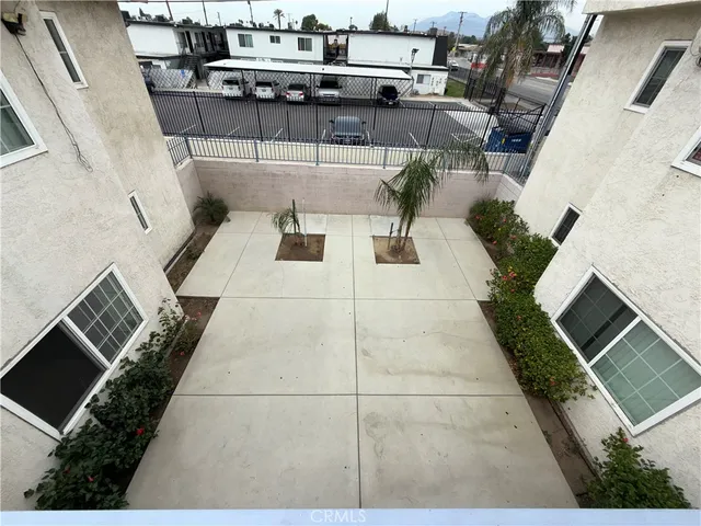 a view of a porch with furniture and a yard