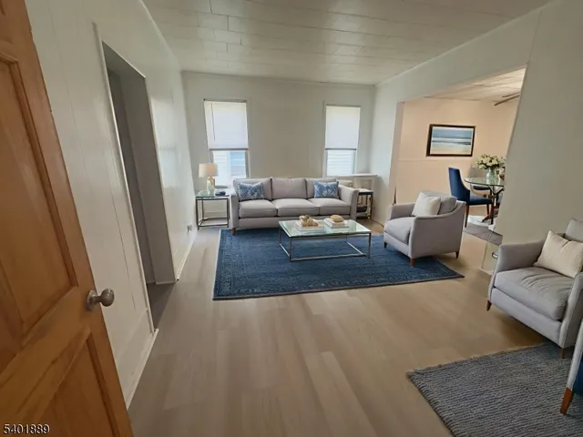 a living room with furniture and a rug