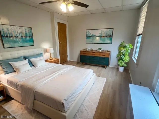 a bedroom with bed and a chandelier