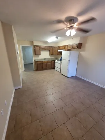 a bathroom with a granite countertop toilet a sink and a mirror