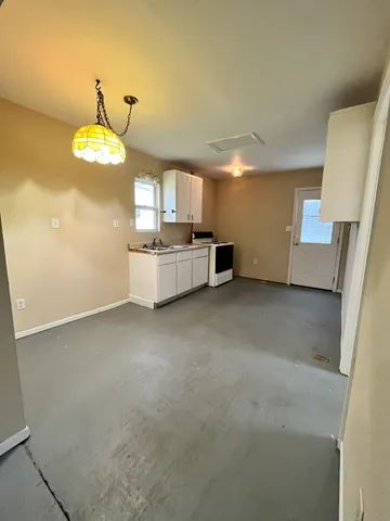 a kitchen with a stove and a refrigerator