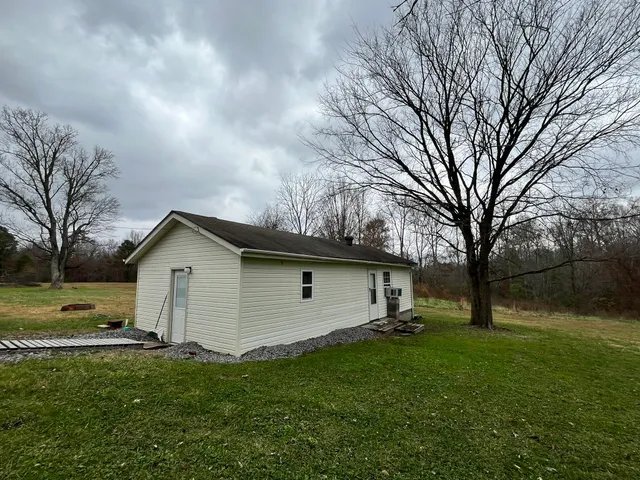 a view of a backyard with large trees