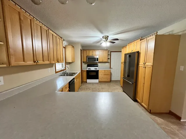 a kitchen with refrigerator and cabinets