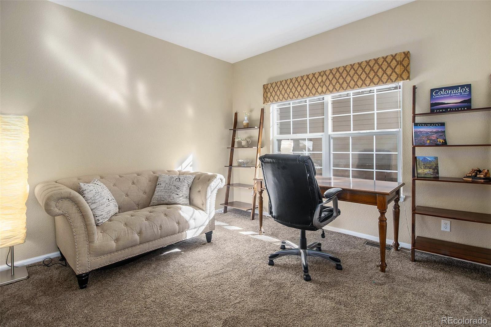 1082 Riddlewood Road Highlands Ranch, CO 80129 - Photo 12 of 28 a living room with furniture and a window