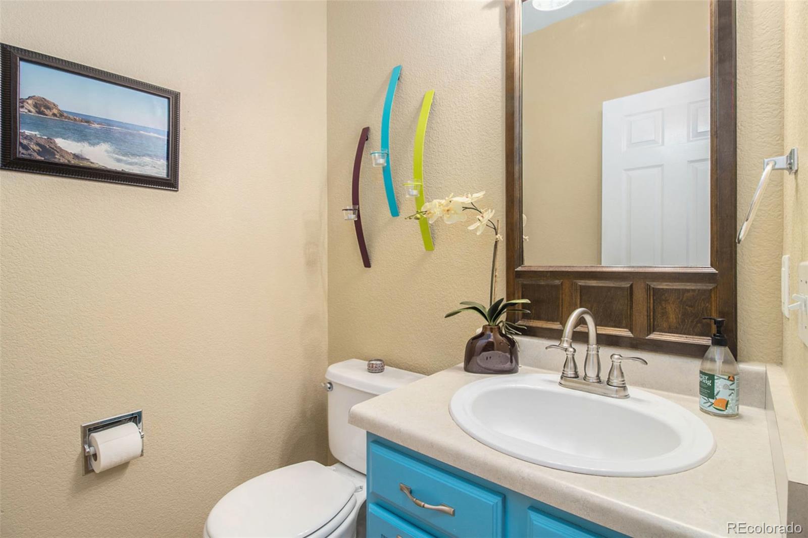 1082 Riddlewood Road Highlands Ranch, CO 80129 - Photo 14 of 28 a bathroom with a toilet sink and mirror