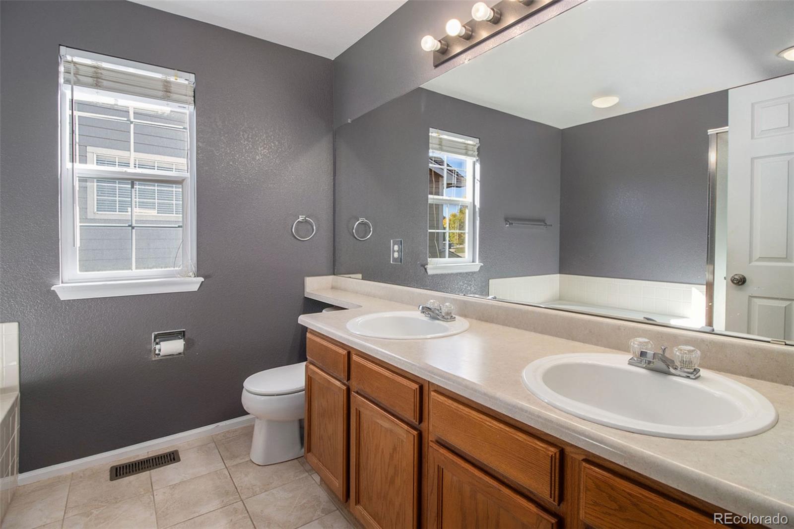 1082 Riddlewood Road Highlands Ranch, CO 80129 - Photo 17 of 28 a bathroom with a sink toilet and window