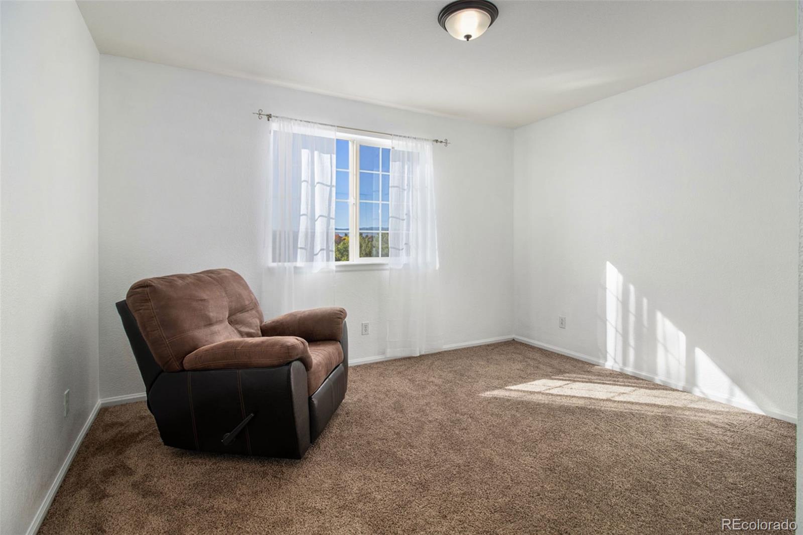 1082 Riddlewood Road Highlands Ranch, CO 80129 - Photo 21 of 28 a living room with furniture and a window