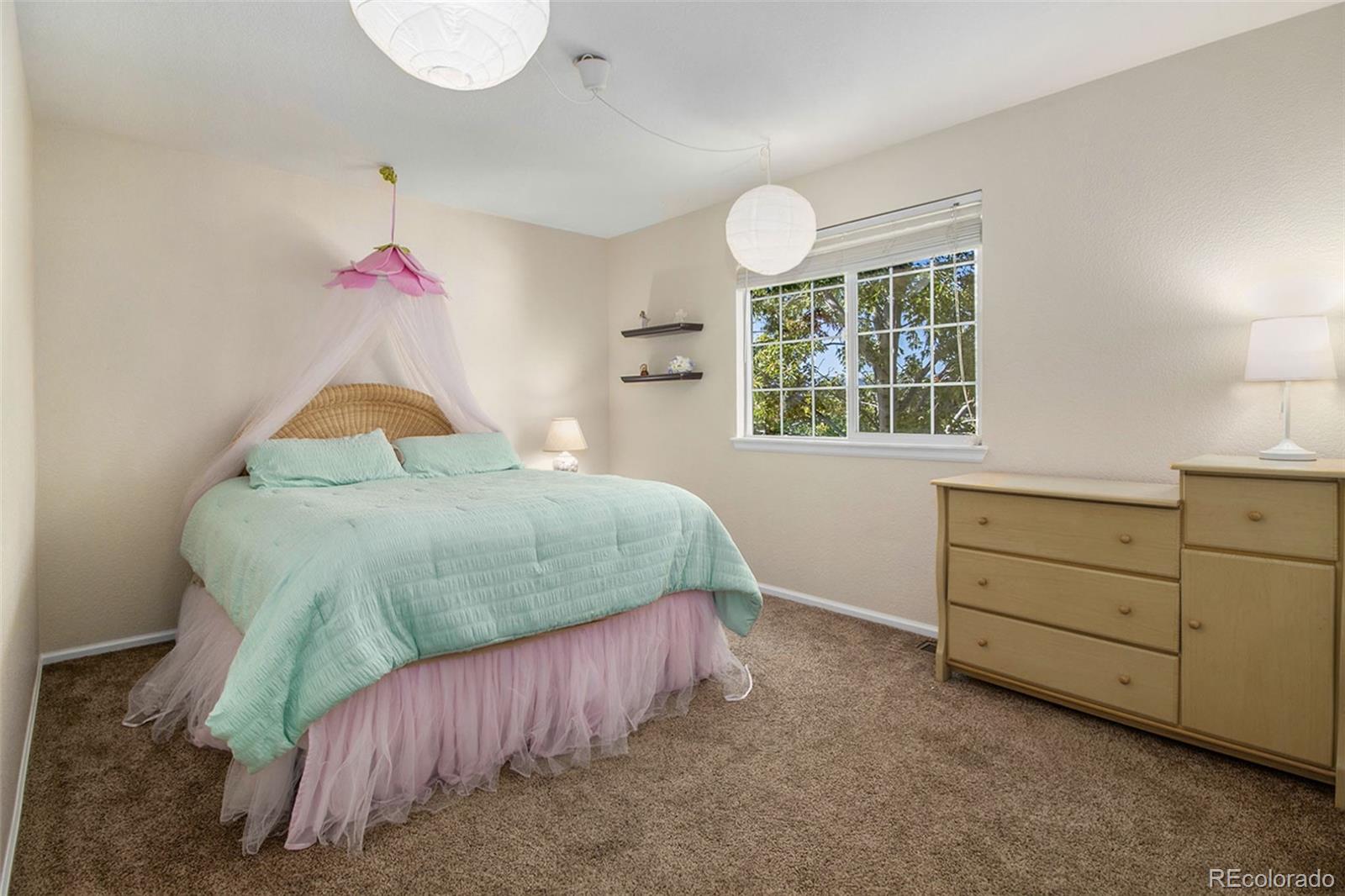 1082 Riddlewood Road Highlands Ranch, CO 80129 - Photo 22 of 28 a bedroom with a bed and window