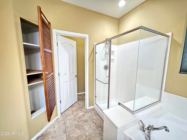 a bedroom with a bed and a television