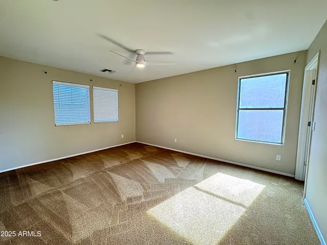a view of a terrace with chairs and potted plants