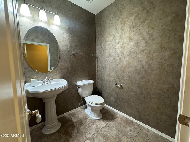 a large kitchen with stainless steel appliances granite countertop a stove and a wooden cabinets