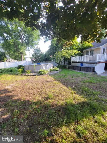 a backyard of a house with a yard and outdoor seating