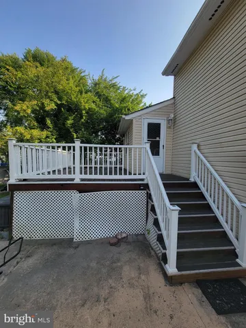 a view of balcony with wooden floor and a potted plant