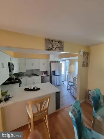 a kitchen with a table and chairs in it