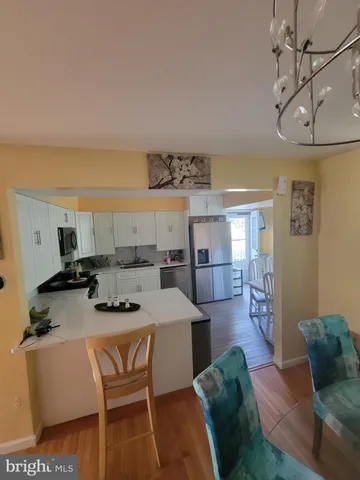 a kitchen with a table chairs stove and cabinets