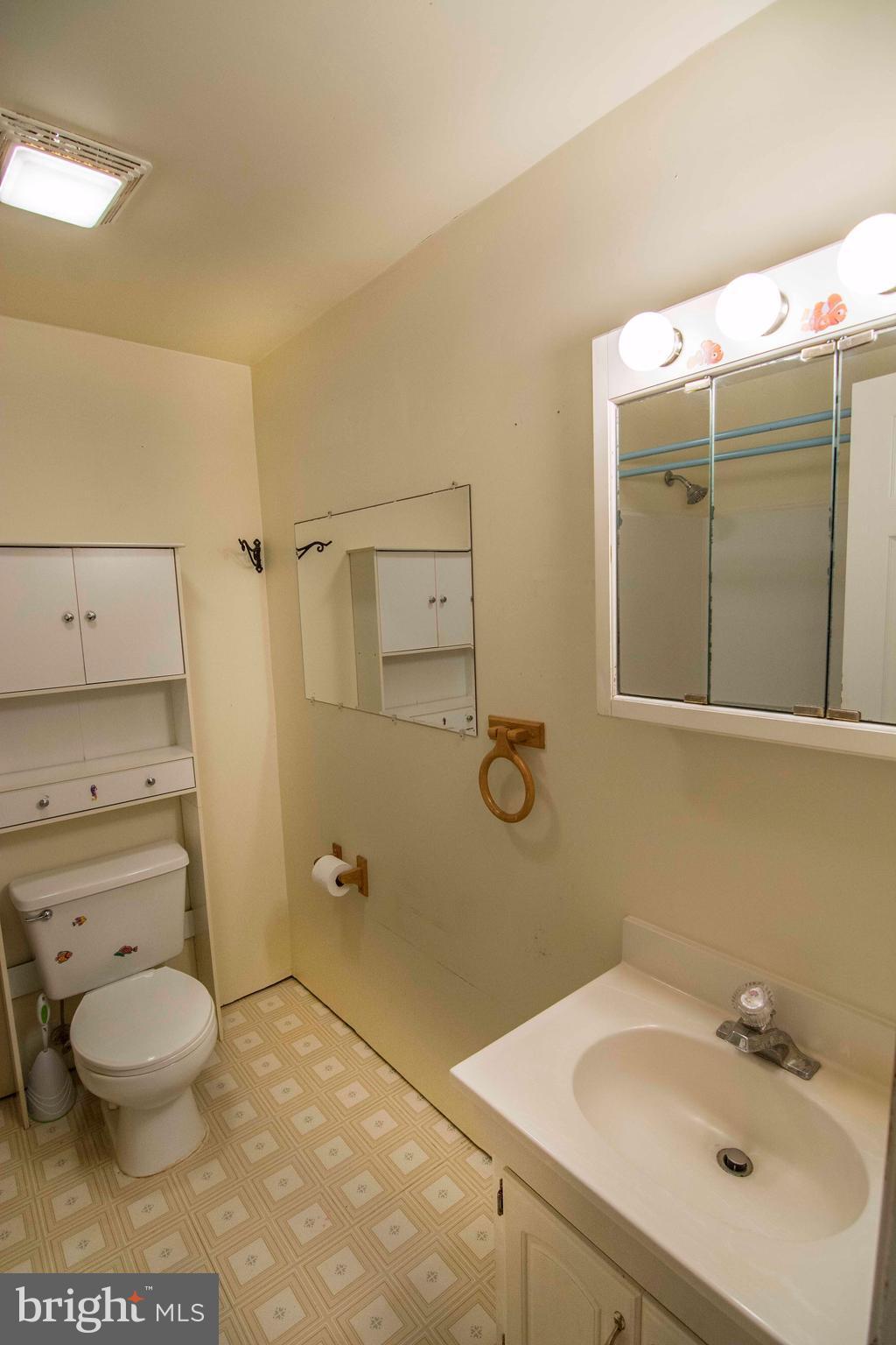 7403 Garrison Road Manassas, VA 20111 - Photo 22 of 28 a bathroom with a sink a toilet and shower