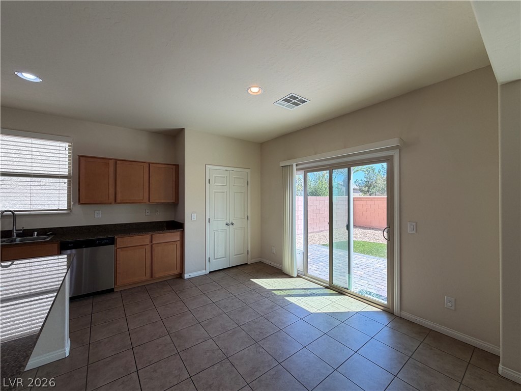 442 White Heart Road Las Vegas, NV 89148 - Photo 6 of 25 Tiled flooring and sliding glass doors connect this versatile dining space directly to the backyard.