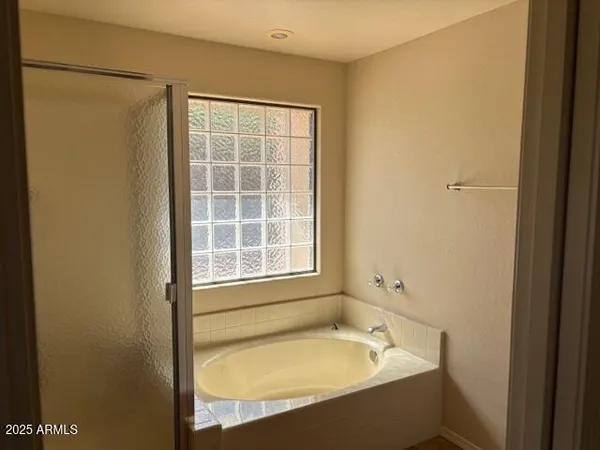 a bathroom with a sink vanity mirror and shower