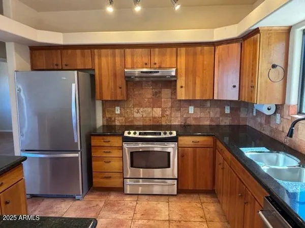 a kitchen with a stove sink and refrigerator