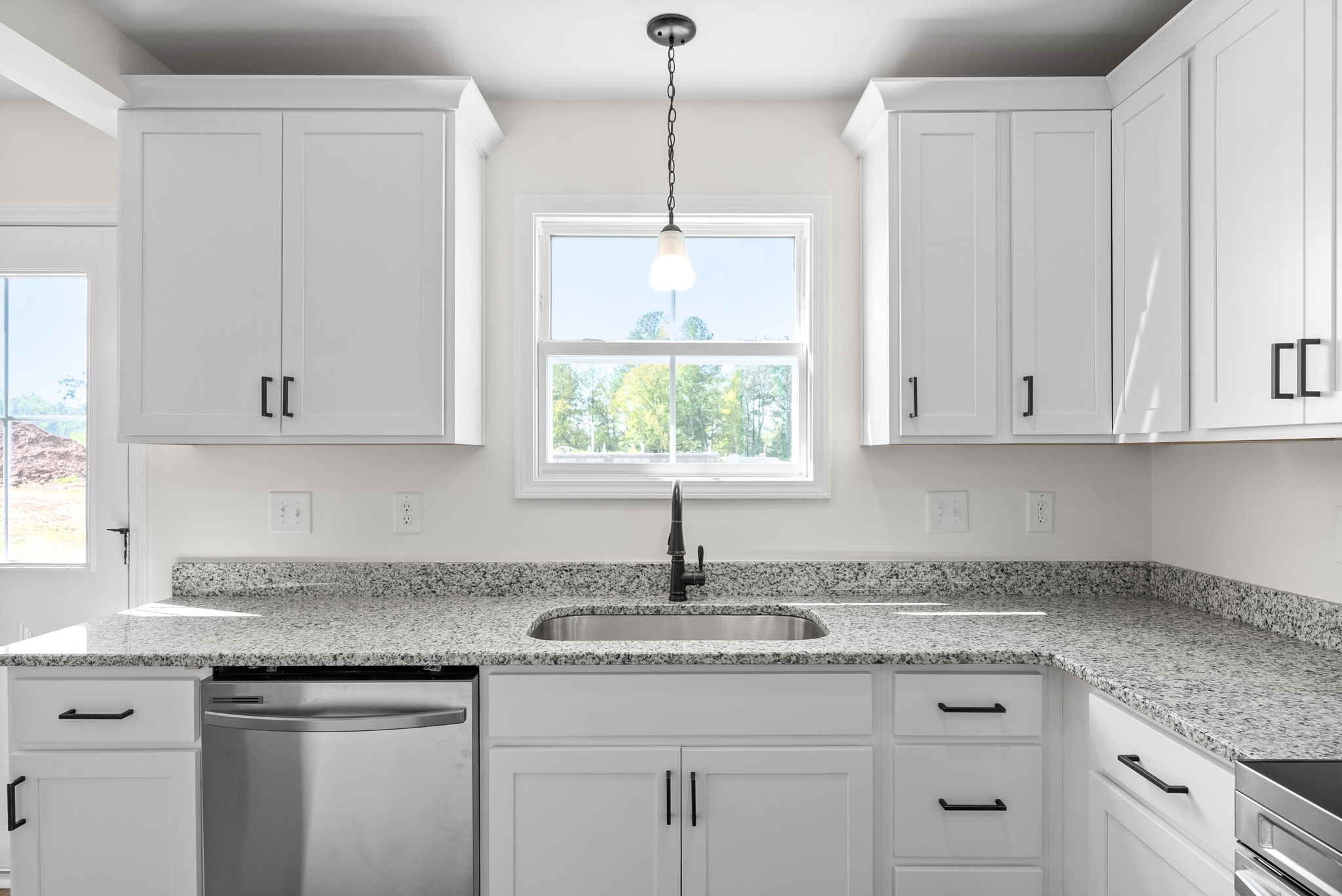 148 Quarry Rdg Road Clarksville, TN 37043 - Photo 14 of 37 a kitchen with granite countertop white cabinets and a window