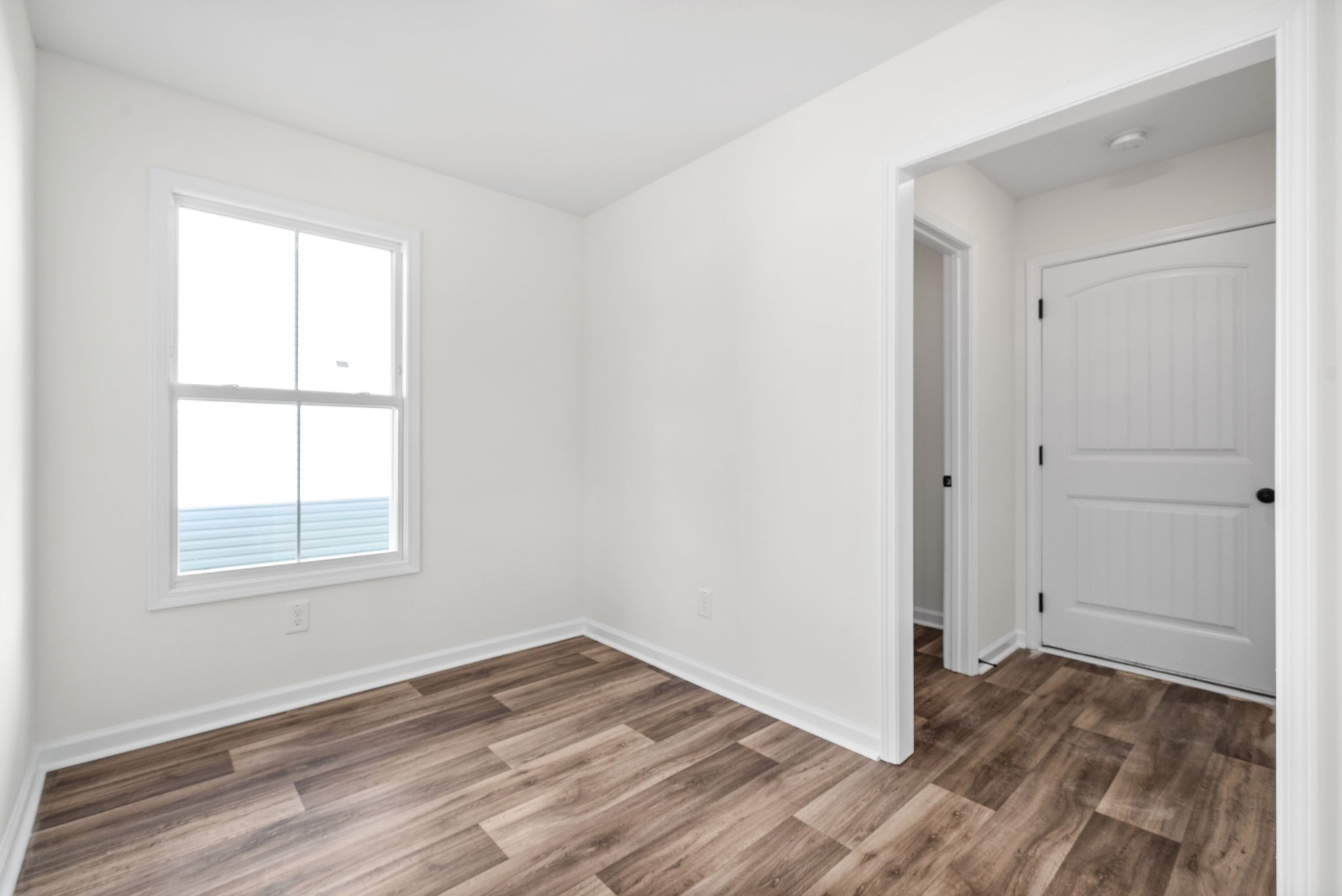 148 Quarry Rdg Road Clarksville, TN 37043 - Photo 18 of 37 an empty room with wooden floor and windows
