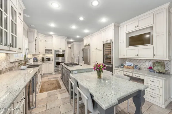 a kitchen with sink stove and cabinets