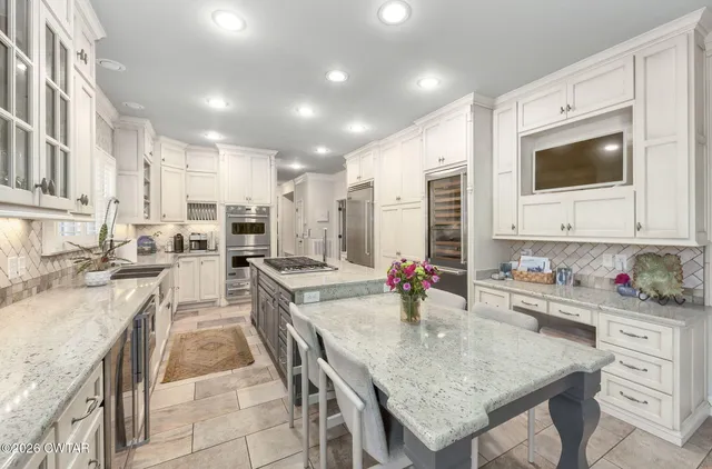 a kitchen with sink stove and cabinets