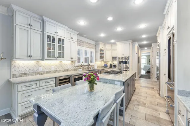 a kitchen with stainless steel appliances granite countertop a sink and stove