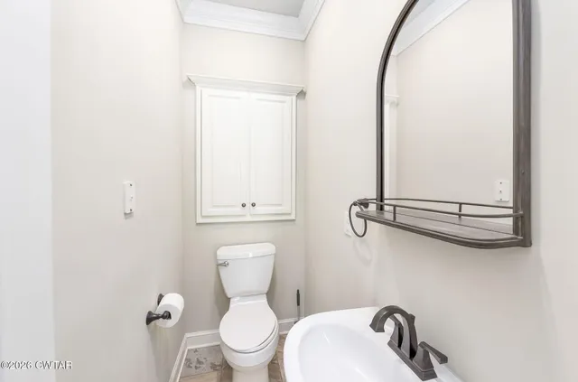 a bathroom with a granite countertop sink toilet a mirror and shower
