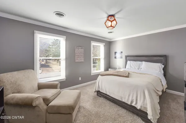 a bedroom with a bed and a large window