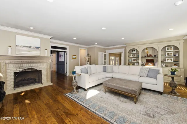 a living room with furniture fireplace and window