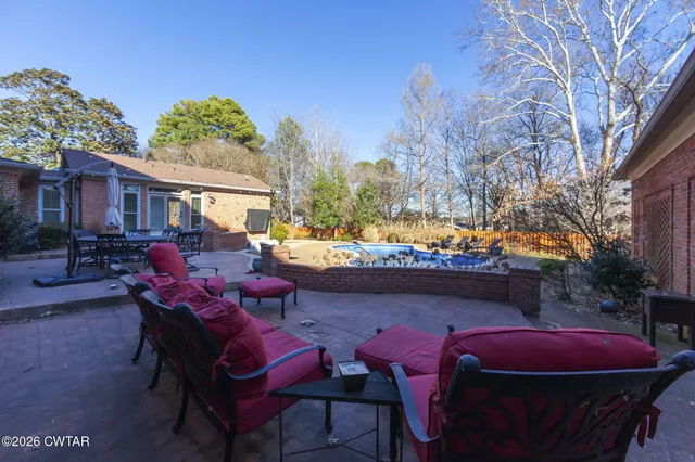 an aerial view of a swimming pool with outdoor seating and mountain view