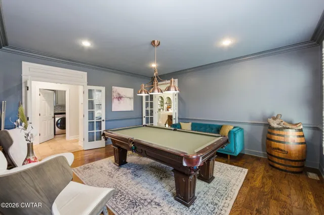 a room with pool table table soccer and windows