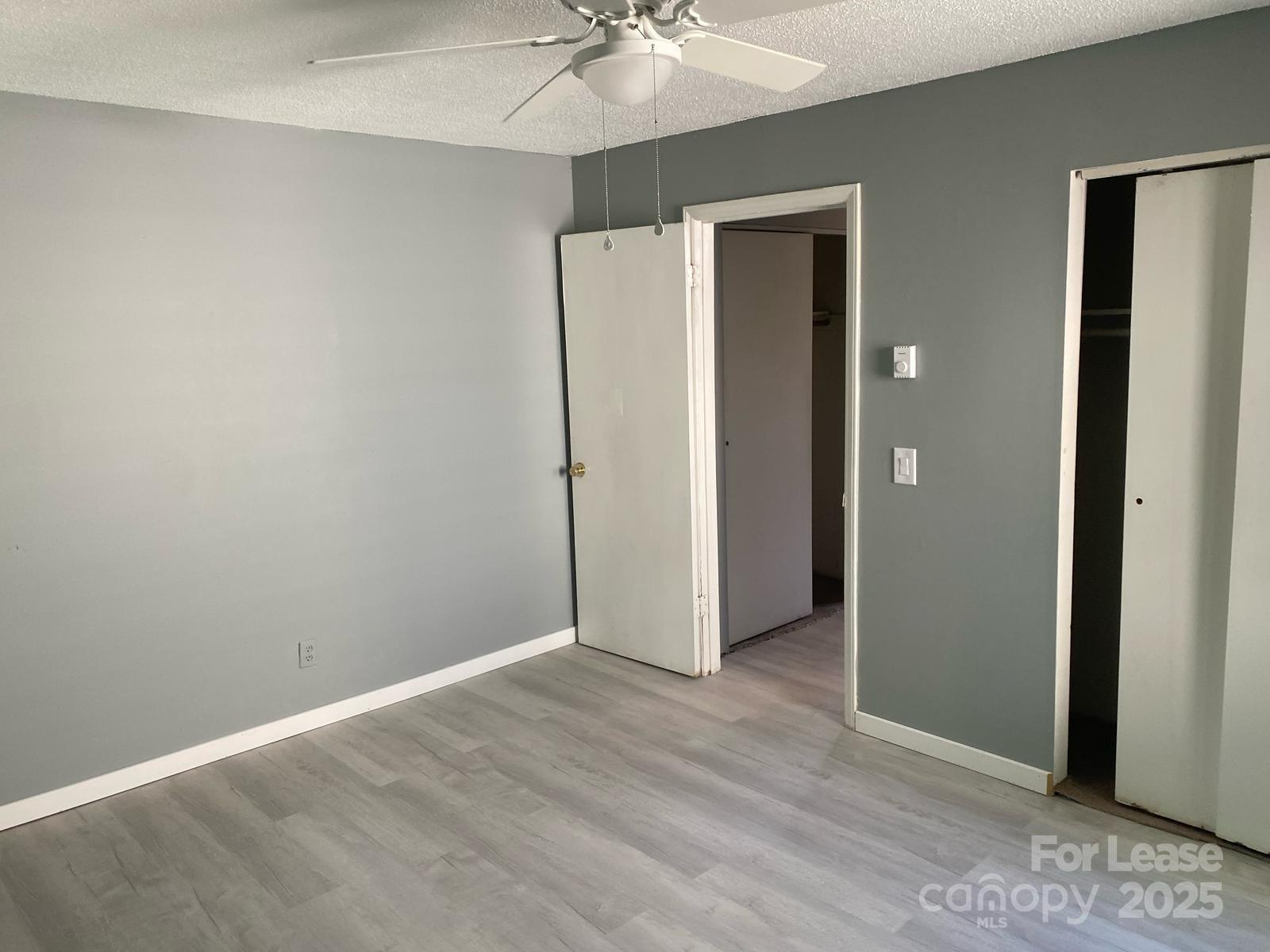 1966 Lakeview Road, Unit 12 Asheboro, NC 27203 - Photo 12 of 14 an empty room with a chandelier fan and closet area