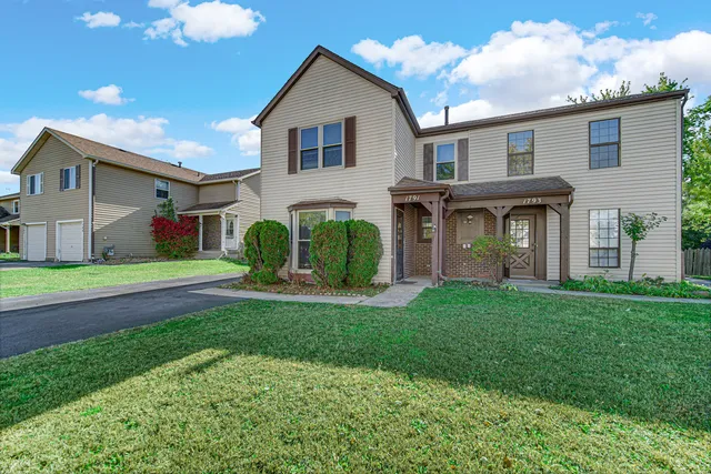a front view of house with yard and green space