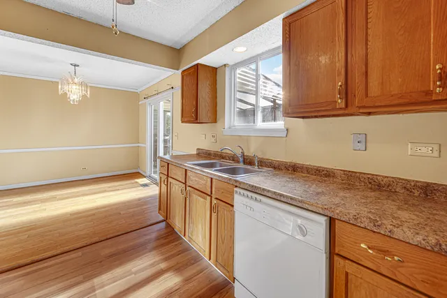 a bathroom with a granite countertop sink and a bathtub