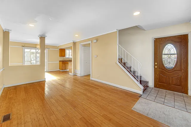 a view of an entryway with wooden floor