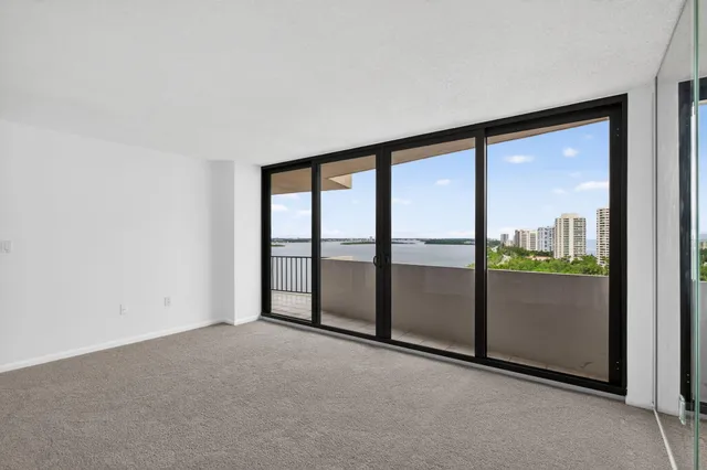a view of an empty room with windows and city view