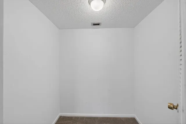a view of an empty room with a floor to ceiling window