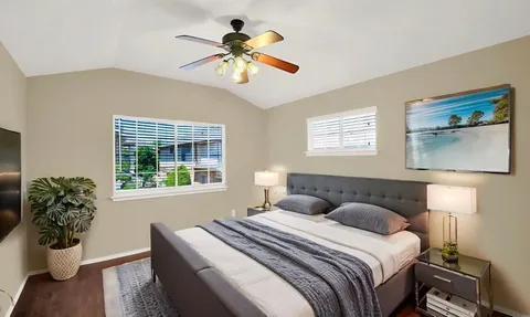 a bedroom with a large bed and a window