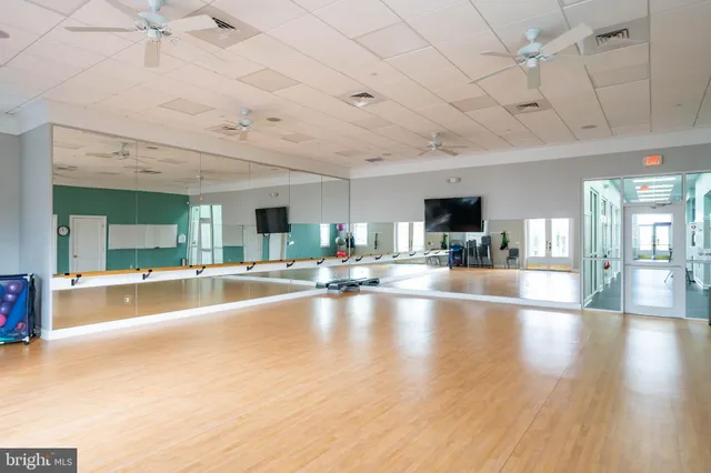 a view of living room with kitchen island granite countertop furniture and a flat screen tv