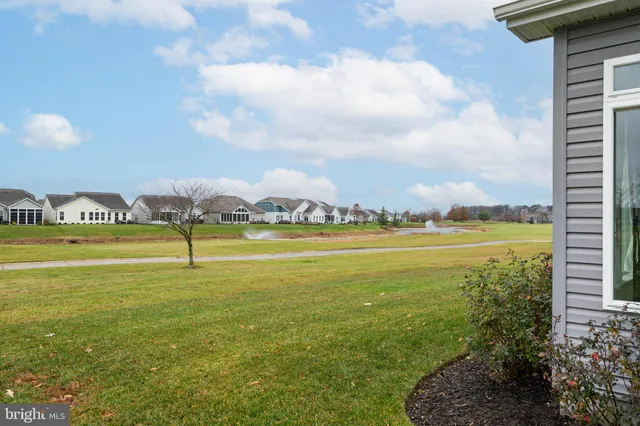 a view of a lake with houses in the back