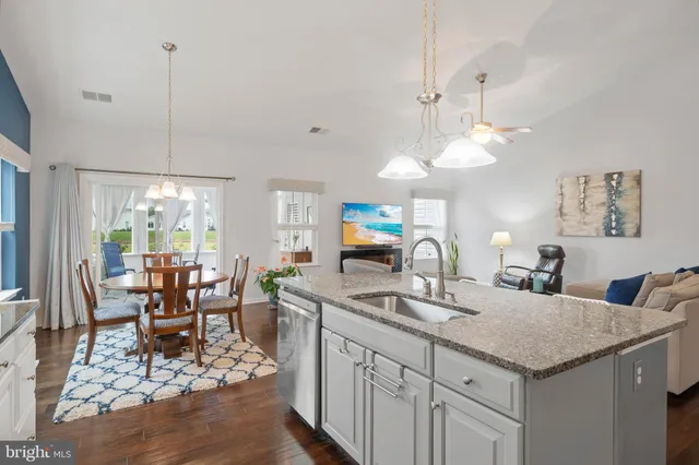 a kitchen with center island table and chairs in it