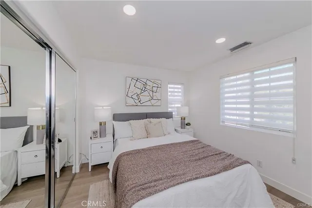 a bedroom with a large bed and a window