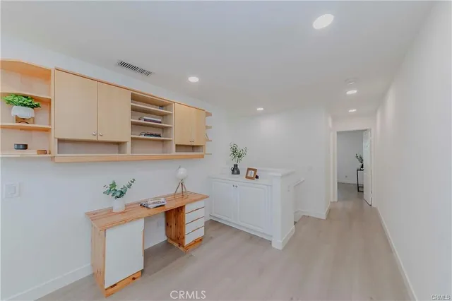 a view of kitchen with stainless steel appliances cabinets