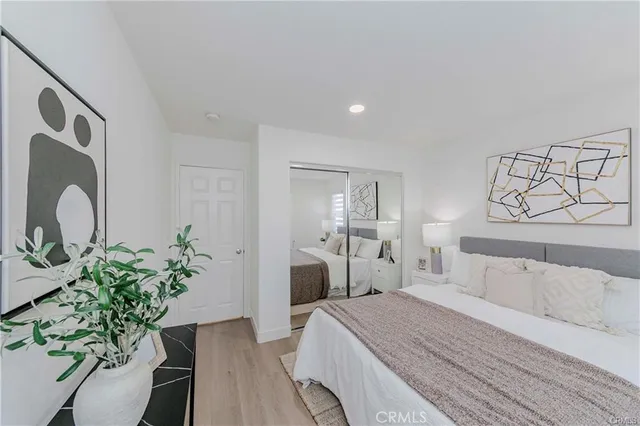 a bedroom with a bed and a potted plant